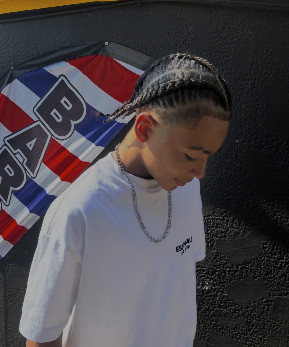 Braided style with a clean taper by Jazzie's Barbershop
